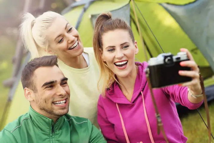 woman taking a group selfie