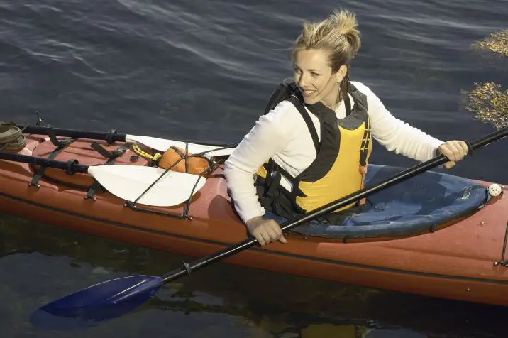 woman in a kayak wearing a pfd