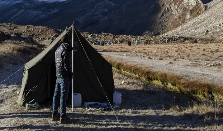 canvas tent in front of mountains