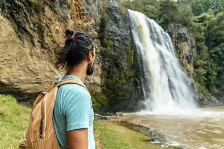 hiker at waterfall