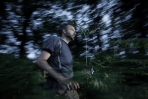 man running through woods